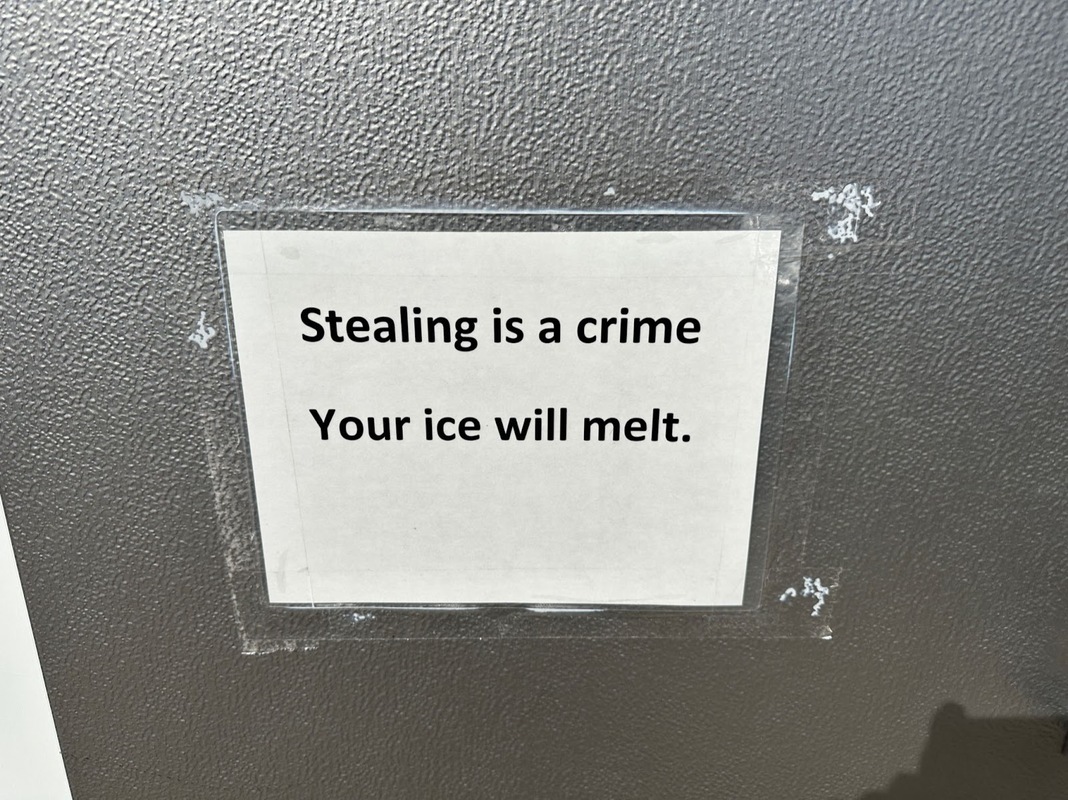 Stealing prevention sign seen on a gas station ice cooler - Swipe File